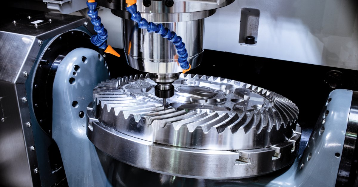 A modern CNC milling machine operates on a large metal cogwheel. The CNC machine's holder keeps the cog in place.